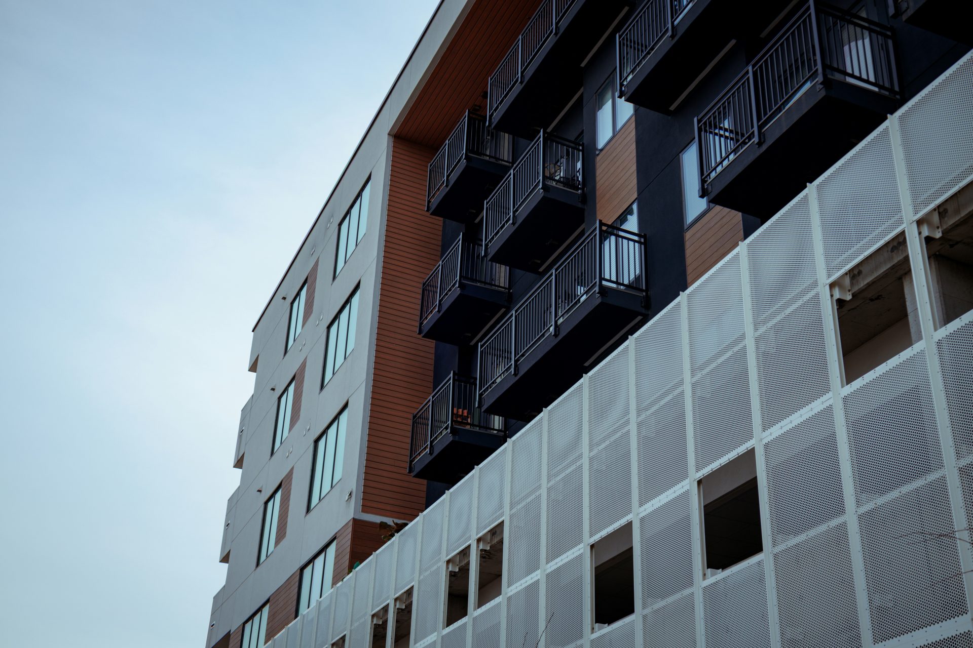 Modernes Gebäude mit Balkonen vor klarem Himmel